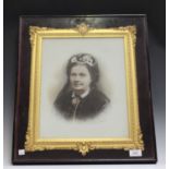 A late Victorian opalotype photograph portrait of a lady, mounted within a gilt composition frame