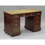 A late Victorian mahogany twin pedestal desk, the top inset with a gilt-tooled green leather writing