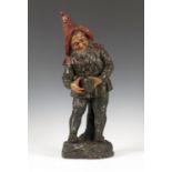 An early 20th century painted pottery figure of a gnome by Johann Maresch, finely modelled holding a