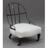 A Victorian part-upholstered iron hoop back nursing chair, the seat upholstered in calico, raised on
