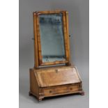 A 19th century George I style walnut swing frame dressing table mirror, the fall front above a
