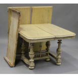 A late 19th century French bleached oak extending dining table with three extra leaves, raised on