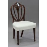 A George III Sheraton period mahogany side chair with carved decoration, the overstuffed seat raised