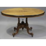 A late Victorian walnut oval tip-top breakfast table with inlaid decoration, raised on fluted