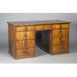 A George III figured mahogany twin pedestal desk, the crossbanded top inset with a gilt-tooled red