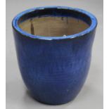 A large modern blue glazed earthenware garden urn of ribbed ovoid form, height 50cm, diameter 51cm.