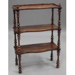 A Victorian rosewood three-tier whatnot, the serpentine fronted shelves on fluted and turned