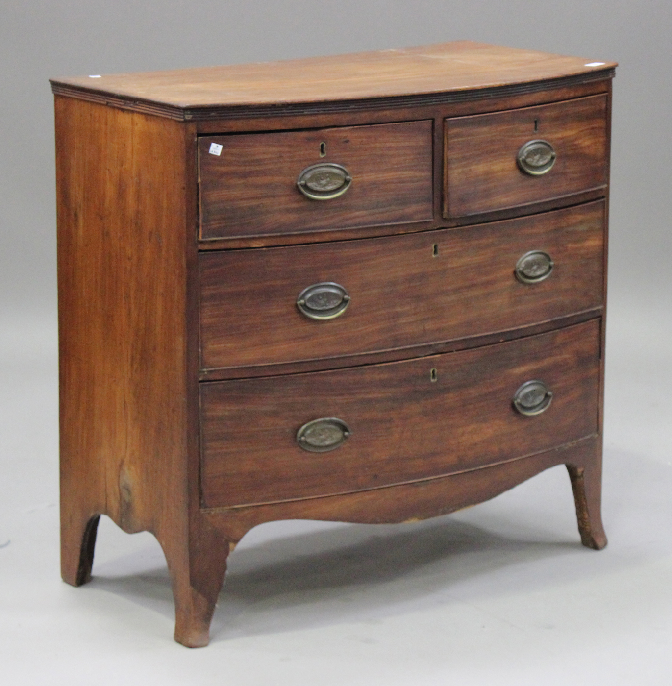 A late George III mahogany bowfront chest of two short and two long drawers, on splayed bracket