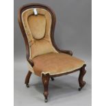 A late Victorian walnut showframe lady's salon chair, upholstered in velour, on cabriole legs,