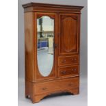An Edwardian mahogany and satinwood crossbanded wardrobe, fitted with a full-length mirror, the base