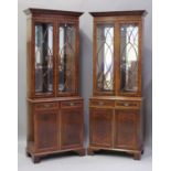 A pair of late 20th century reproduction burr walnut bookcase cabinets, each fitted with a pair of