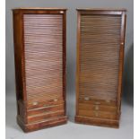 A near pair of early 20th century Continental walnut tambour fronted side cabinets, fitted with