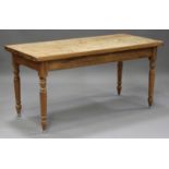 A 20th century pine kitchen table, the rectangular top raised on turned legs, height 76cm, length