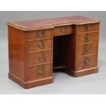 An early Victorian mahogany kneehole desk, the inverted breakfront top inset with a gilt-tooled