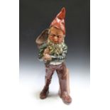 An early 20th century Continental painted and cast composition figure of a gnome, modelled holding a