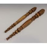 Two 19th century Indian turned and carved ivory fan handles, the stems with coloured detailing,