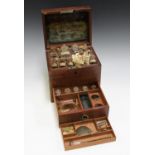 A George III mahogany apothecary's box, the hinged lid enclosing labelled glass bottles, the