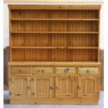 A modern pine dresser, the shelf back above drawers and cupboards, height 200cm, width 183cm,