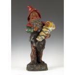 An early 20th century painted pottery figure of a gnome by Johann Maresch, finely modelled holding a