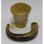 A 19th century carved horn walking stick handle and a horn beaker.Buyer’s Premium 29.4% (including