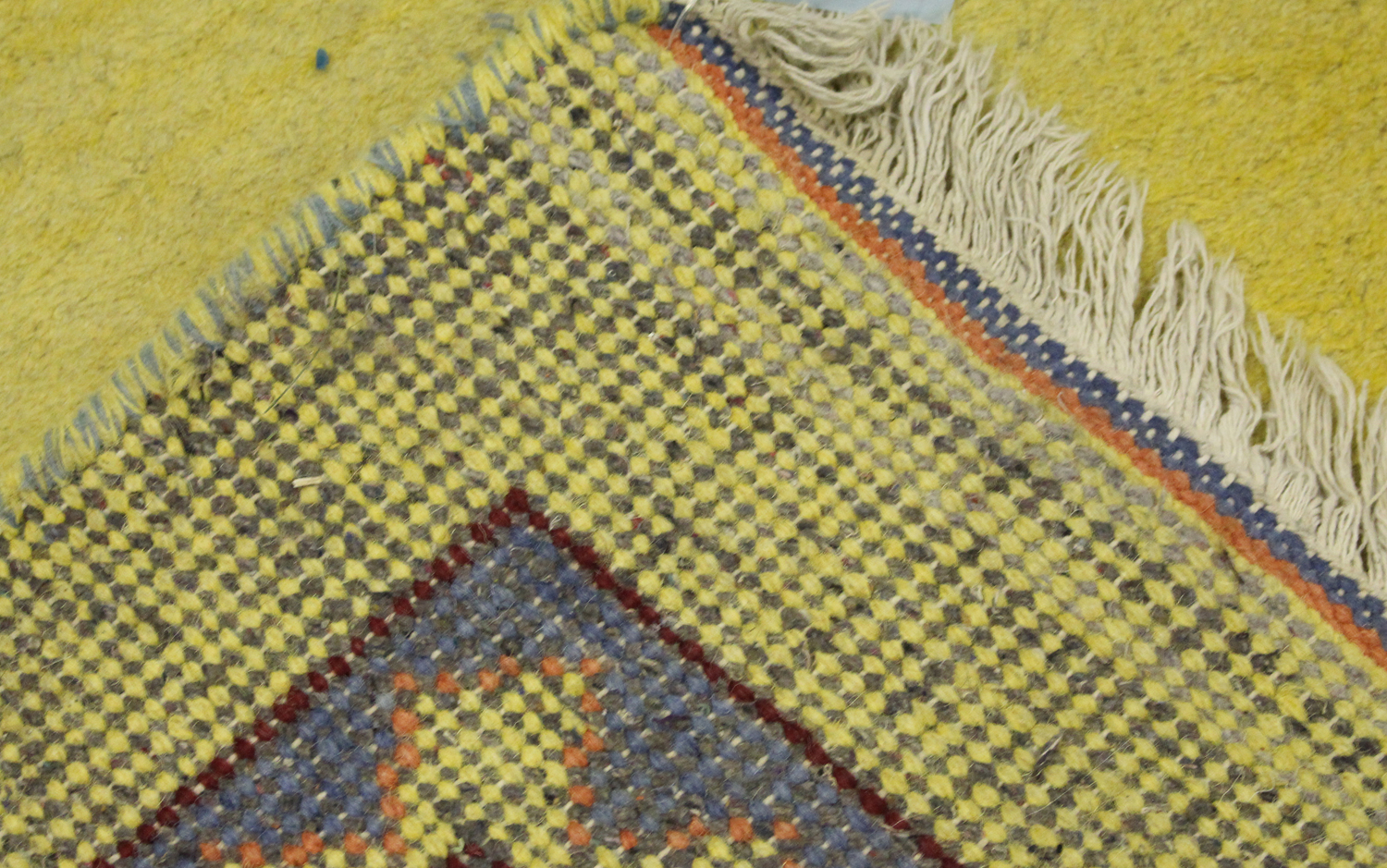 A Persian gabbeh rug, late 20th century, the sparsely decorated yellow field within a blue border, - Image 2 of 2