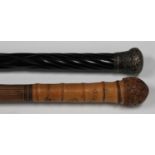 A late 19th/early 20th century Japanese bamboo walking stick, finely carved and incised with bands