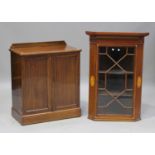 An Edwardian mahogany side cabinet with boxwood stringing, fitted with two panel doors, on a