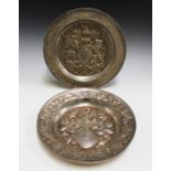 Two silvered and partially gilded dishes, both decorated with heraldic crests, diameter 35cm.Buyer’s