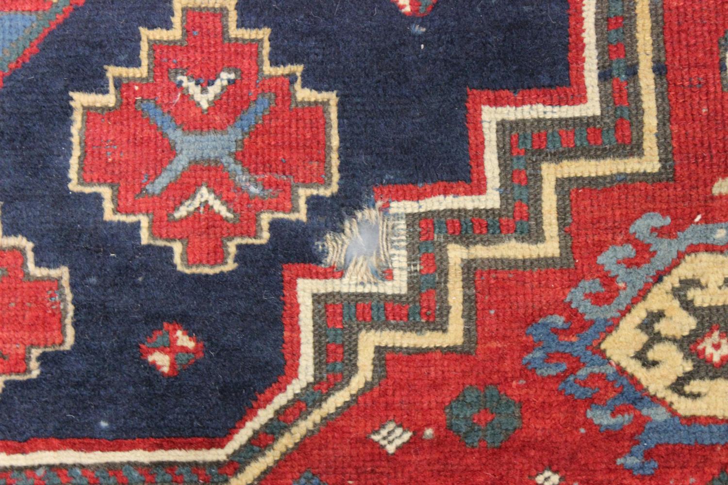 A Kazak rug, West Caucasus, early 20th century, the red field with three large medallions, supported - Image 2 of 4