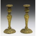 A pair of French Rococo style cast ormolu candlesticks, decorated in relief with birds, flowers