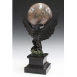 A 20th century Empire style brown and green patinated cast bronze model of an eagle with