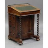 An early Victorian rosewood Davenport, the hinged writing surface inset with gilt-tooled green