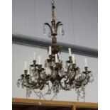 A 20th century cast gilt metal eighteen-light chandelier, hung with overall cut glass tear shaped