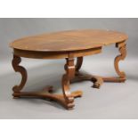 A 20th century French oak extending dining table, the oval top with a single extra leaf, raised on