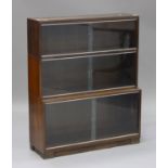 A mid-20th century mahogany three-section 'Minty' bookcase with glazed sliding doors, height