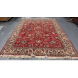 A Tabriz carpet, Central Persia, mid-20th century, the red field with overall scrolling tendrils and