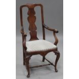 An early 20th century Queen Anne style walnut elbow chair, the shaped splat back and scroll arms