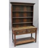 A 19th century oak dresser, the shelf back above two frieze drawers, on chamfered supports united by