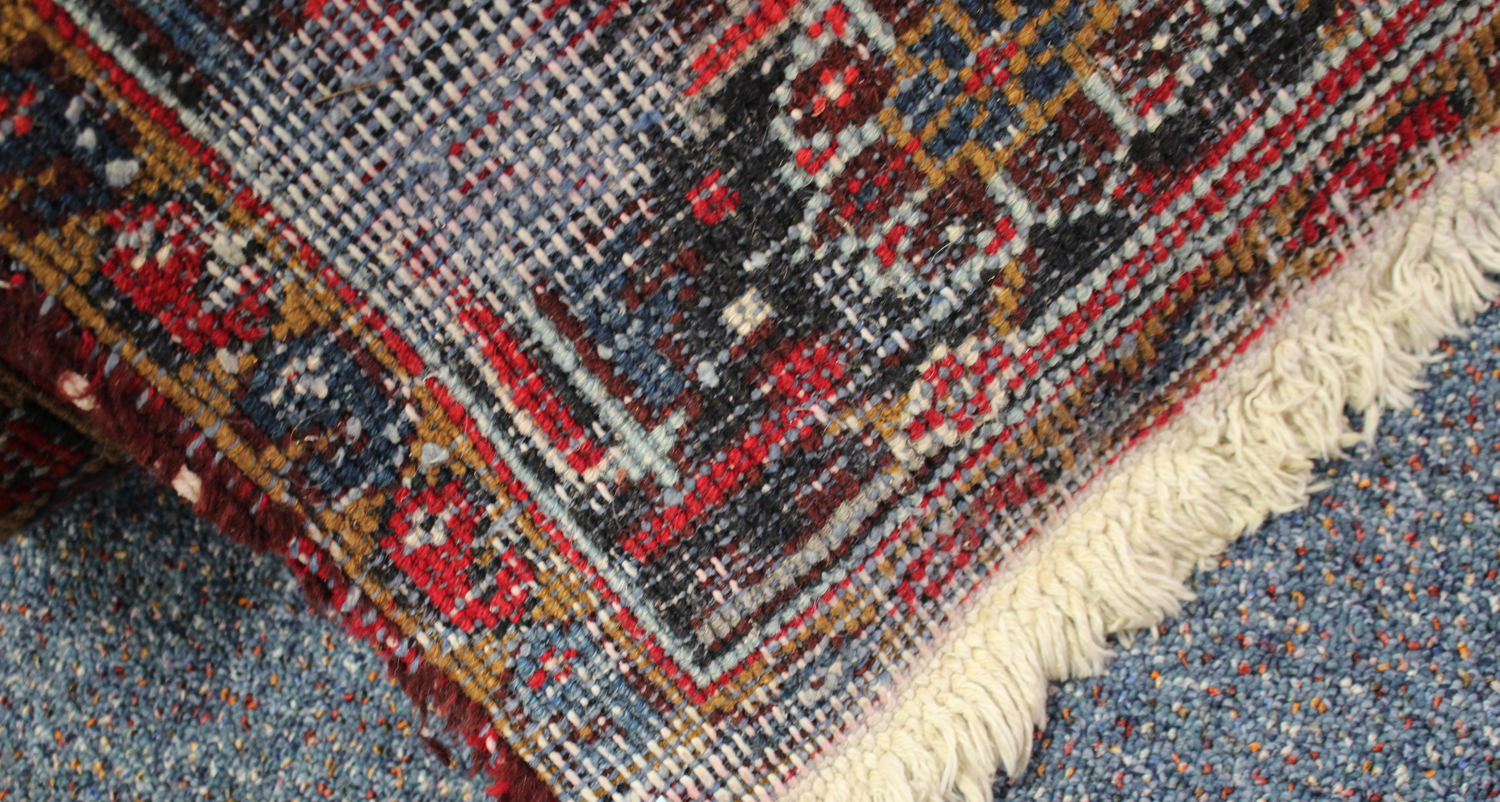 A Heriz carpet, North-west Persia, mid-20th century, the red field with overall palmettes and - Image 2 of 2