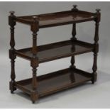 A Victorian mahogany three-tier buffet, on turned and block supports with brass castors, height