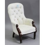 A Victorian mahogany framed armchair with carved decoration, upholstered in cream velour, on