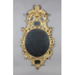 An 18th century Rococo giltwood framed wall mirror with leaf and scroll decoration, 123cm x 66cm.