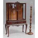 A late 20th century mahogany display cabinet, the glazed top above frieze drawers, on carved