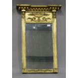 A Regency giltwood pier mirror, the inverted break front pediment above applied floral scroll