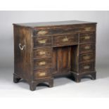 A late 18th/early 19th century Colonial camphor campaign kneehole desk with brass recessed