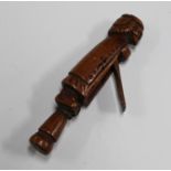 A 17th century carved treen combination pipe tamper snuff box, modelled in the form of a gentleman