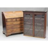 A George III mahogany bureau with an associated bookcase top, the fall front revealing a fitted