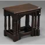 A 20th century oak nest of three occasional tables, on turned and block legs, height 48cm, width