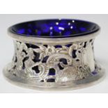 A late Victorian silver table salt in the form of an Irish dish ring, decorated in relief and