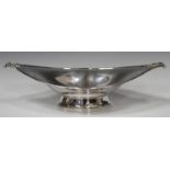 A George V silver boat shaped dish with foliate moulded handles, on an oval foot, London 1912 by
